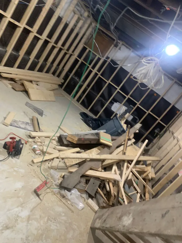 Before: Framing offcuts and scrap cleared from a basement